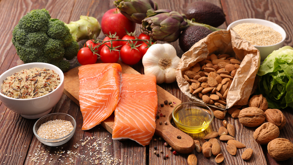 An assortment of brain healthy food, such as salmon, nuts, and pumpkin