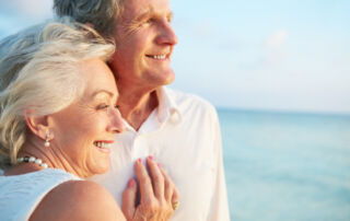 A happy senior couple smiling outdoors