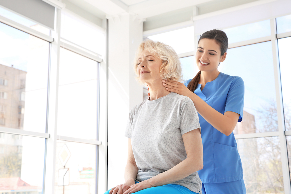 A senior woman visits a massage therapist