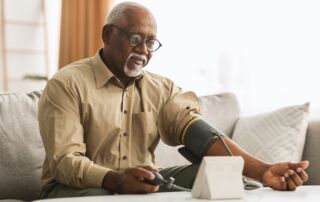 A senior man takes his blood pressure