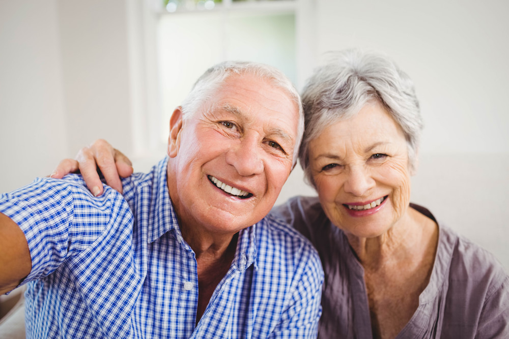 A happy senior couple smile and pose for a photo together