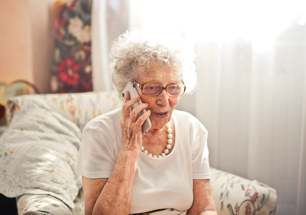 A senior woman talks on her cell phone