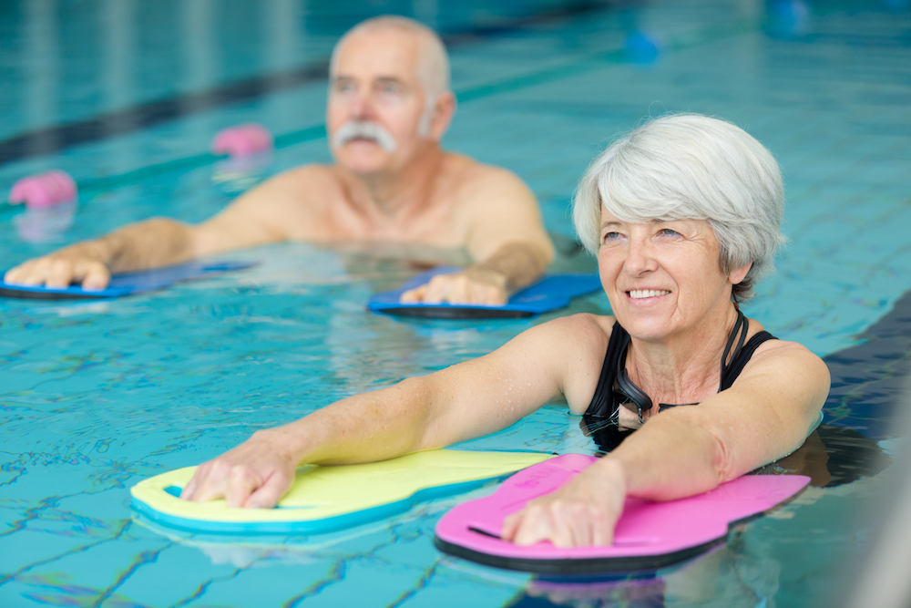 Two seniors doing aqua therapy in the pool